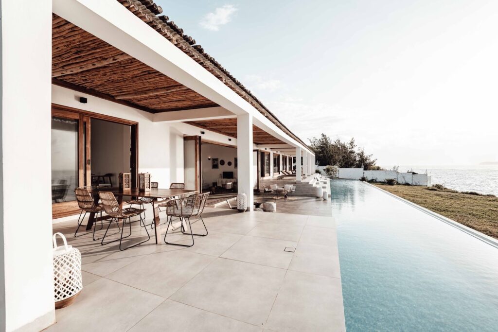 Photo by Keegan Checks Contemporary villa with an infinity pool overlooking the ocean, perfect for luxury getaways.