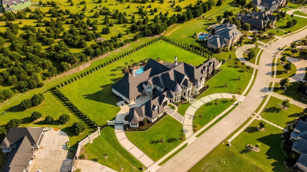Photo by Daniel Barnes aerial photography of house with green yard